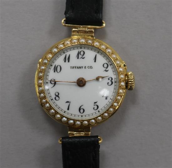 A ladys 18ct gold and split pearl set manual wind wrist watch, retailed by Tiffany & Co.